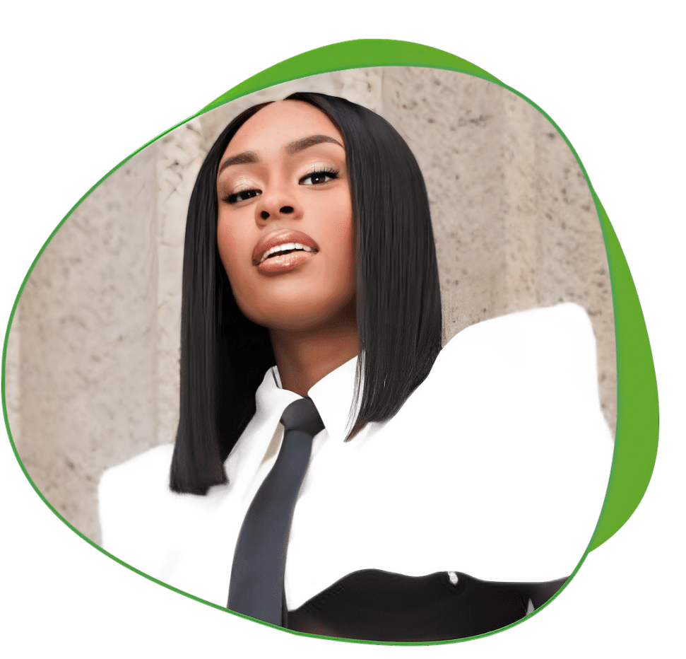 Confident woman in a white blazer and black tie posing.